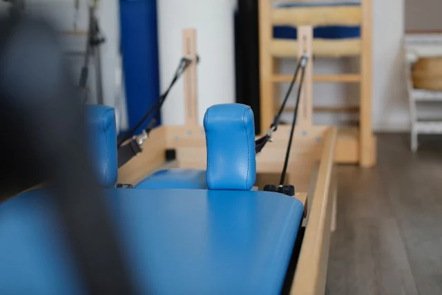 Wooden Pilates Reformer with blue padding