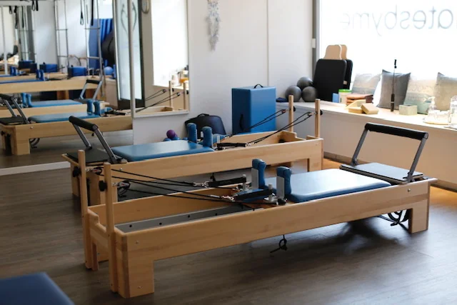 The wooden Reformers and Pilates equipment inside the Zurich studio